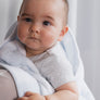 Close-up profile of a baby resting on a parent's shoulder, bundled in a cozy Blue Check Knitted Chenille Blanket.