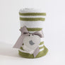 Rolled Knitted Chenille Blanket in Sage Stripes, tied with a gray ribbon and a heart-shaped gift tag on a white background.