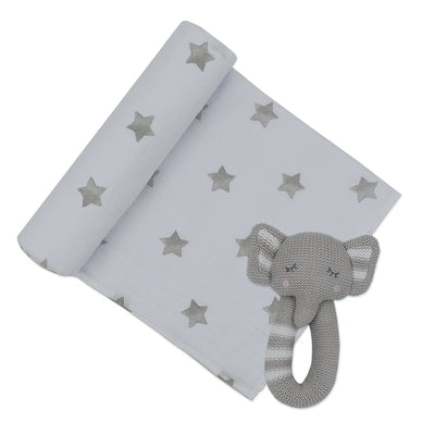Product shot of a baby newborn gift set featuring a white cotton muslin swaddle blanket printed with soft grey stars, partially unrolled next to the coordinating