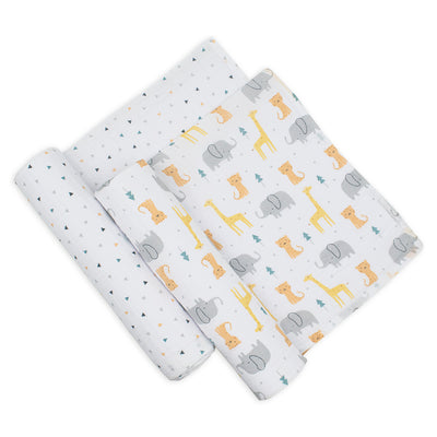 Studio flat lay shot of the two cotton muslin swaddle blankets, showing the triangle dot pattern swaddle rolled up tightly and the safari animal print blanket partially unfolded to reveal its full detailed pattern.