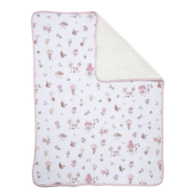 Flat lay view of the Jersey Sherpa Blanket in Mushroom House style, featuring a white cotton jersey top with a pink whimsical mushroom and floral print folded back to reveal a soft cream sherpa fleece lining.