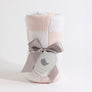 Rolled Pink Check Knitted Chenille Blanket neatly packaged with a grey ribbon and a heart gift tag.
