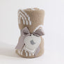 Knitted Chenille Blanket in Taupe Rainbow, neatly rolled and presented with a delicate ribbon and decorative tag, ready for gifting.