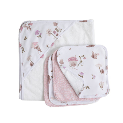 Folded view of the Mushroom House 5-piece baby bath set, showcasing the white terry cotton hooded towel and a stacked assortment of matching pink and white illustrated washcloths.