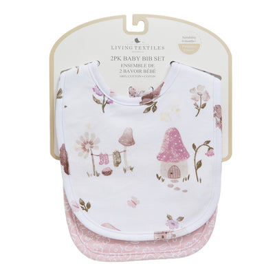 2-pack baby bib set in Mushroom House style, displayed on retail card packaging, featuring a white top bib with an illustrated pink mushroom cottage and woodland pattern over a textured pink backing bib.
