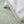 Close-up detail of the plush sage green sherpa border and soft cotton jersey fabric of the Goosey Goosey baby blanket.