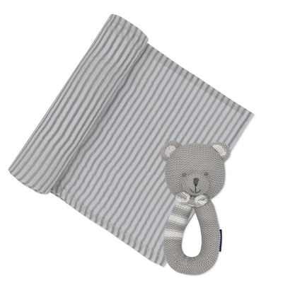 Product shot of a baby newborn gift set featuring a white cotton muslin swaddle blanket printed with classic grey stripes, partially unrolled next to the coordinating 