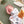 Overhead portrait of a sleeping newborn baby swaddled snugly in the white forest animal jersey blanket, resting on a matching olive green dotted mattress sheet inside a crib with a plush fox mobile spinning above.