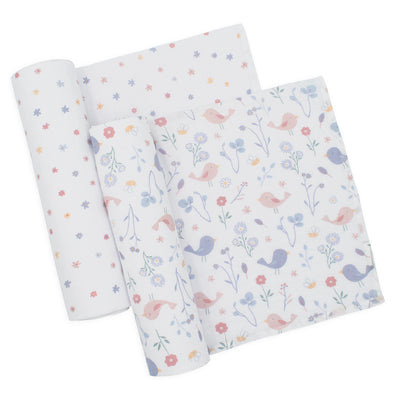 Flat lay studio shot of the two rectangular muslin baby swaddle blankets unfolded and rolled at the ends against a white background, displaying the full print scale and pattern repetition for both designs.